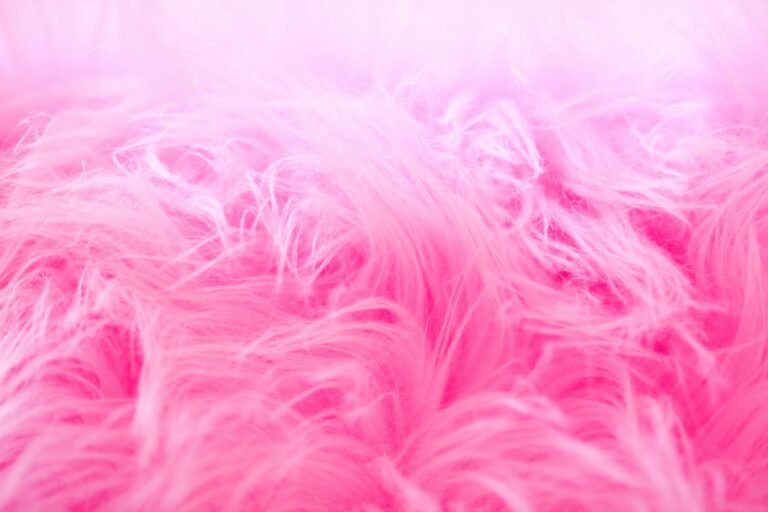 Detailed close-up of a vibrant pink fluffy texture, perfect for backgrounds and creative designs.
